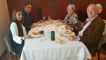 a group of people sitting at a table eating food