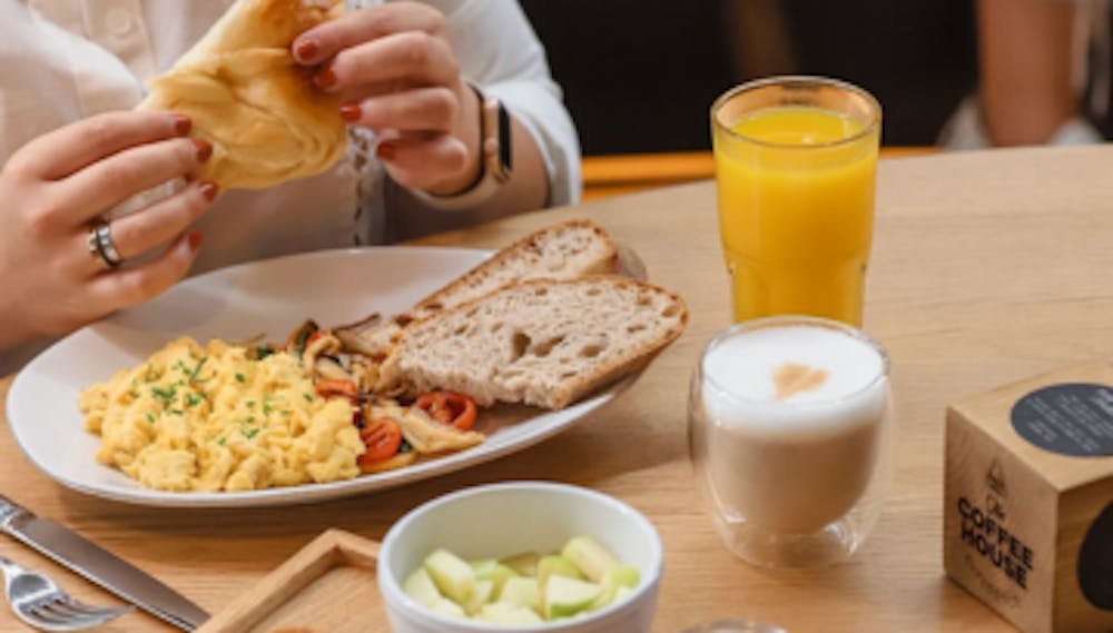 a woman sitting at a table eating food