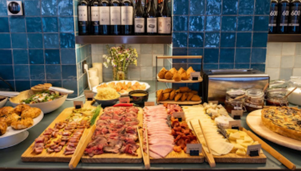 a table topped with plates of food on a counter