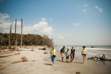 family walking on beach in South Carolina