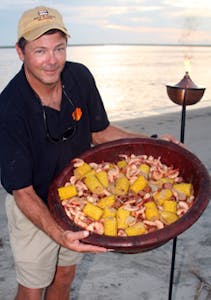 Man holding big pot of Low Country seafood boil