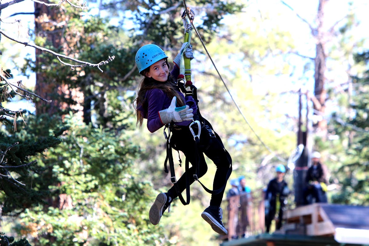 Small girl looking back while zip-lining