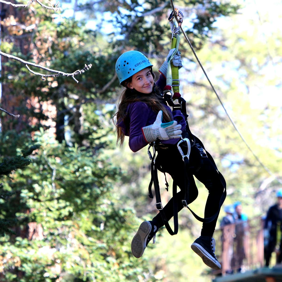 Small girl looking back while zip-lining