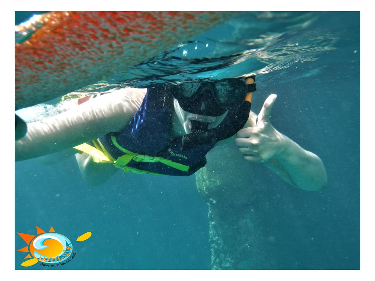girl snorkeling giving thumbs up