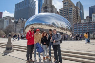 a group of people standing in front of Millennium Park