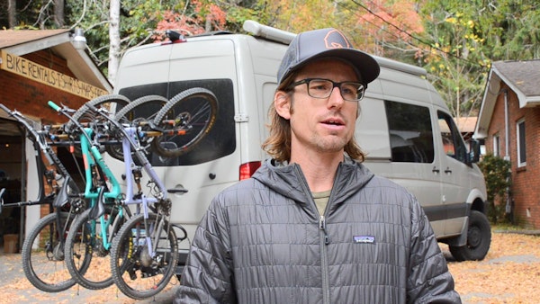 North Carolina mountain bike tour guide next to transport van
