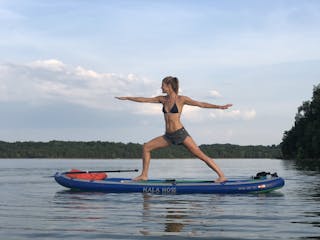a person doing yoga on a paddleboard