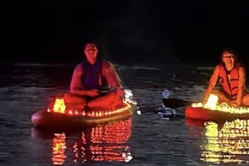 a man riding on the back of a boat in the water