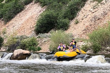a group of people on a raft in a river