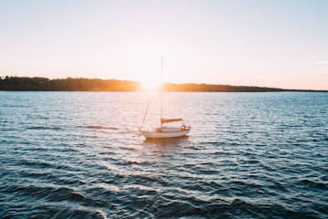 White boat sailing on a sunset
