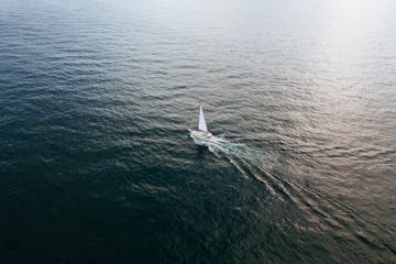 White boat sailing in the middle of the ocean