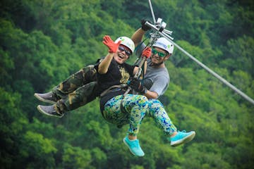 Man and Woman hanging from a zipline