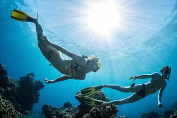 Man and Woman Freediving underwater