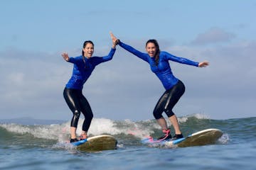 Girls surfing and high fiving