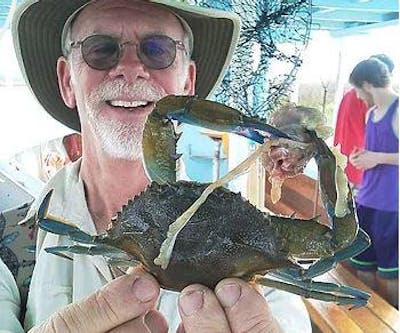 Man showing crab he caught in Hilton Head