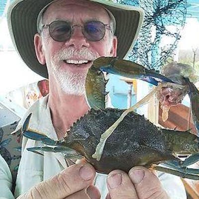 Man showing crab he caught in Hilton Head