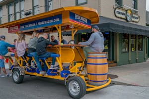 a group of people riding on a Pedal Wagon