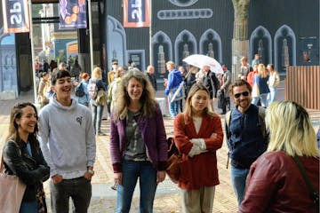 a group of people laughing and walking down the street