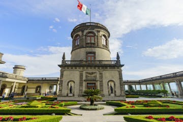a large stone building with Chapultepec Castle in the background