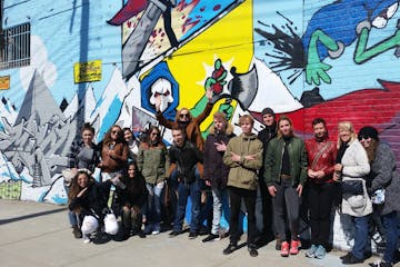 group standing in front of graffiti
