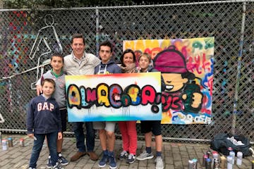 family standing with graffiti canvas