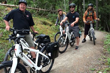 group of people riding bikes on trail