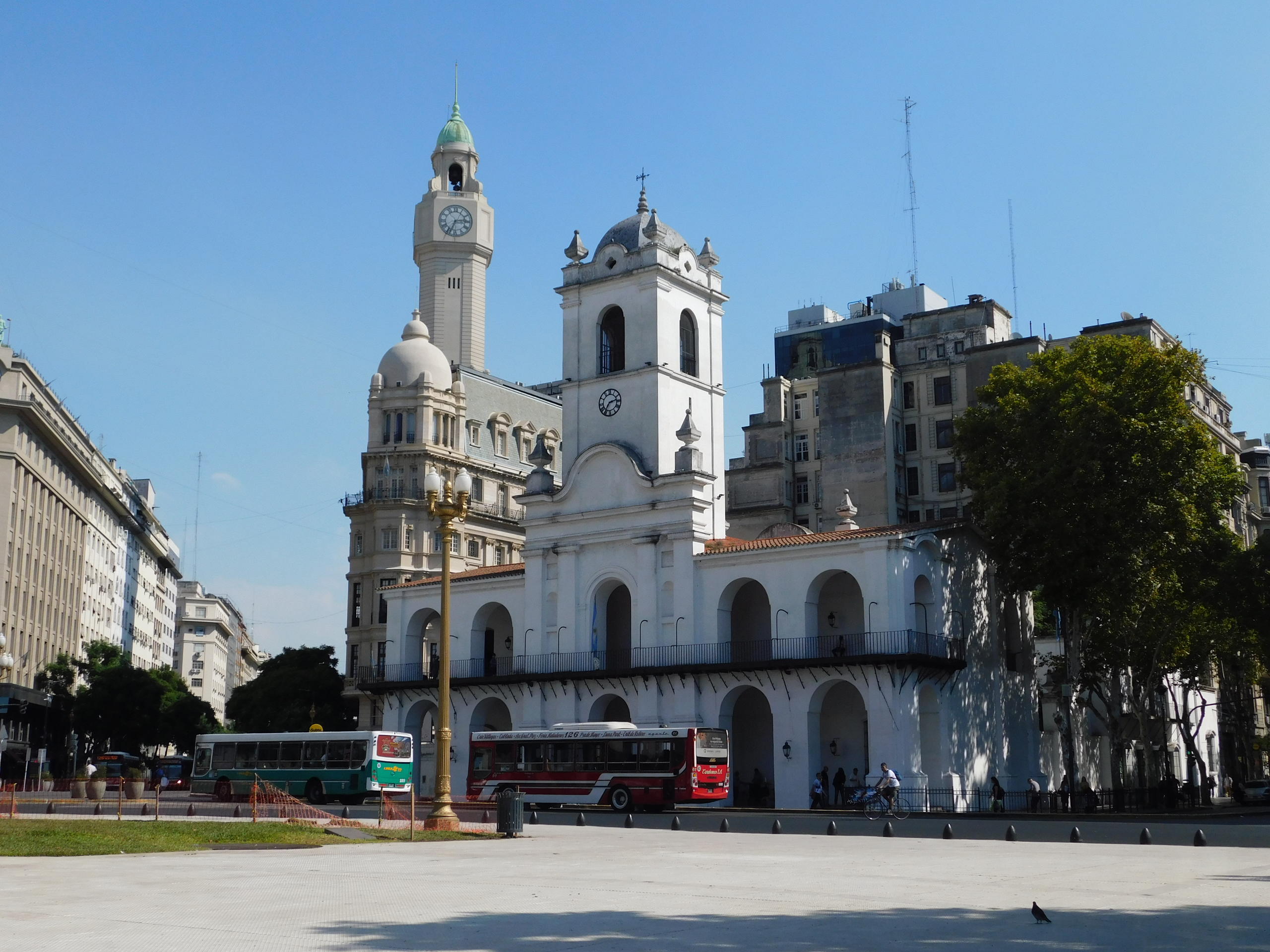 a group of people walking in front of a church with Buenos Aires Cabildo in the background