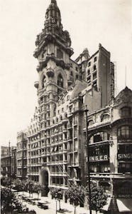 a vintage photo of a clock tower in a city