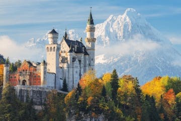 Neuschwanstein Castle and the snow-capped mountains behind