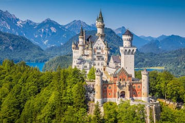 a castle with Neuschwanstein Castle in the background