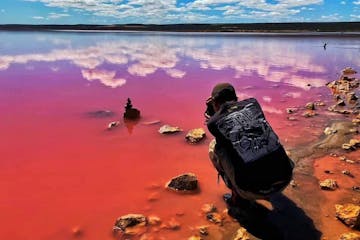 Guy taking a photo on Pink Lake