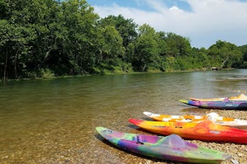 kayaks parked on river bank