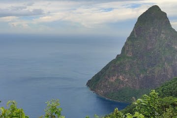 a large body of water with Pitons in the background