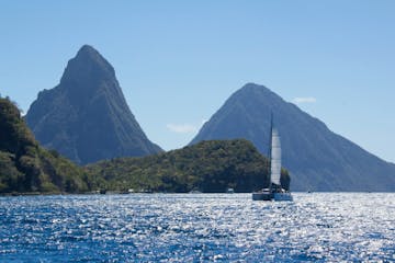 a large body of water with Pitons in the background
