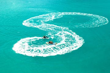 Jet Boat and Banana boat combo, a drone photo of a banana boat ride in Airlie Beach, The Whitsundays.