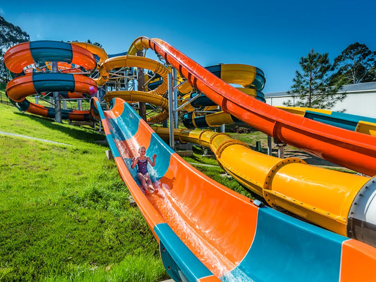 Young girl sliding on water park