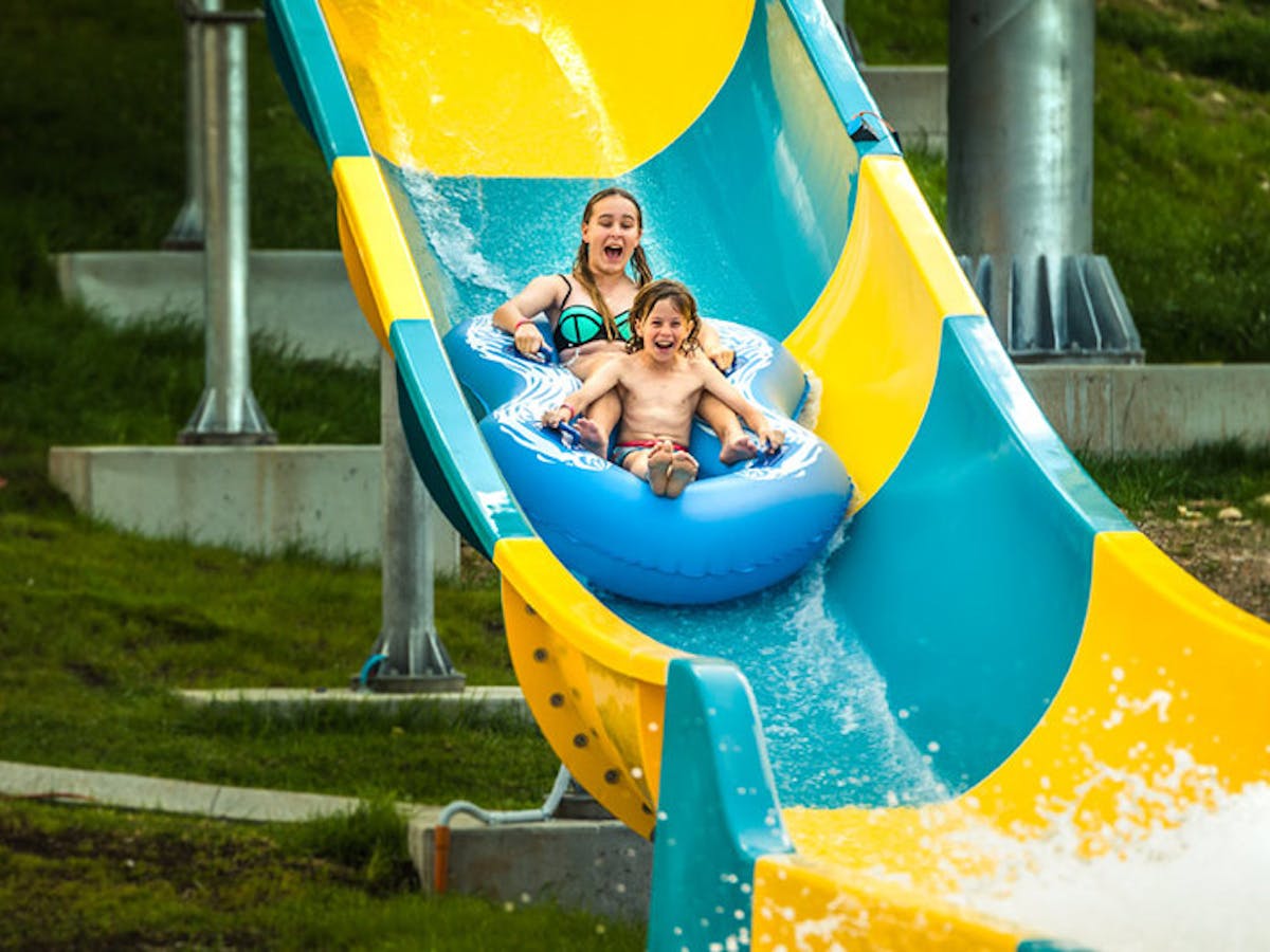 2 kids on a water slide