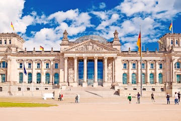 a group of people in front of a large building with Reichstag building in the background