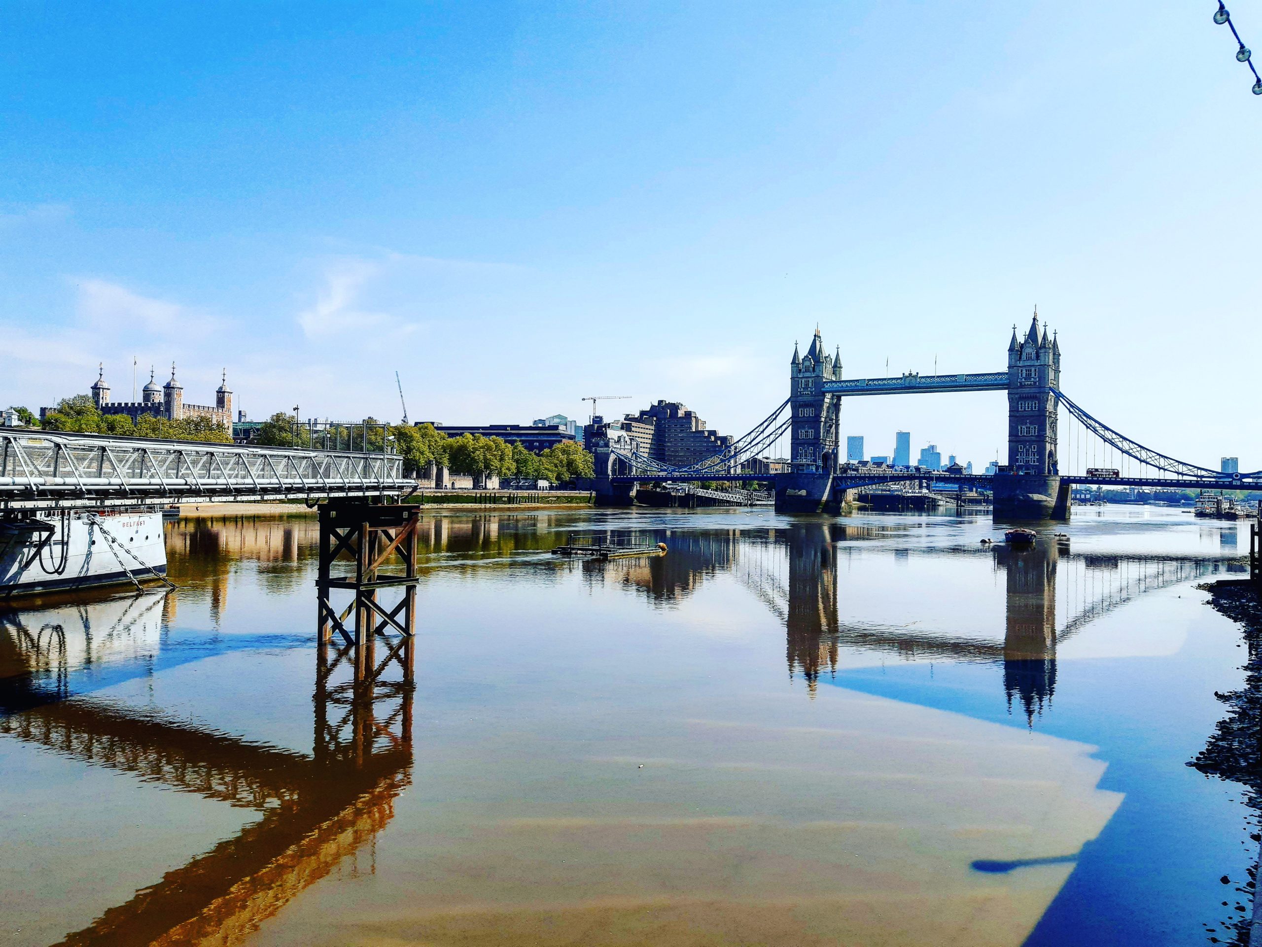 Tower Bridge and the Tower of London: Looking across the River Thames from HMS Belfast - London Cab Tours