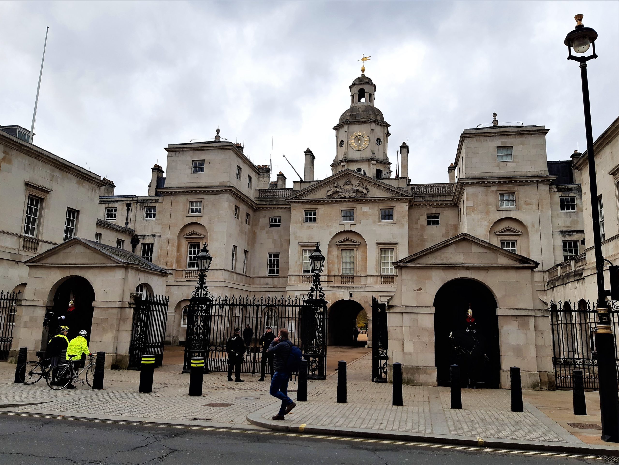 a group of people walking in front of Horse Guards