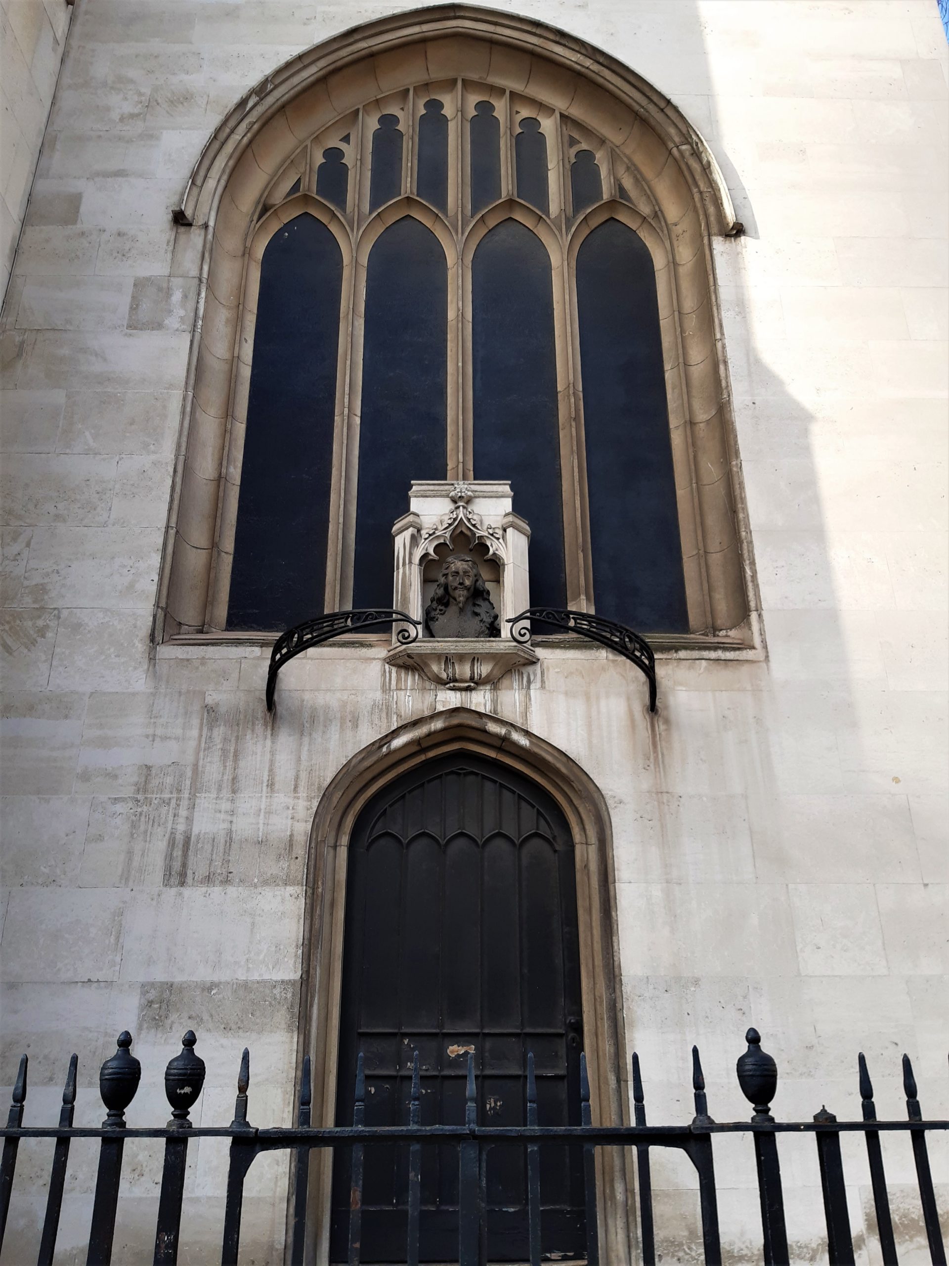 a large stone statue in front of a building