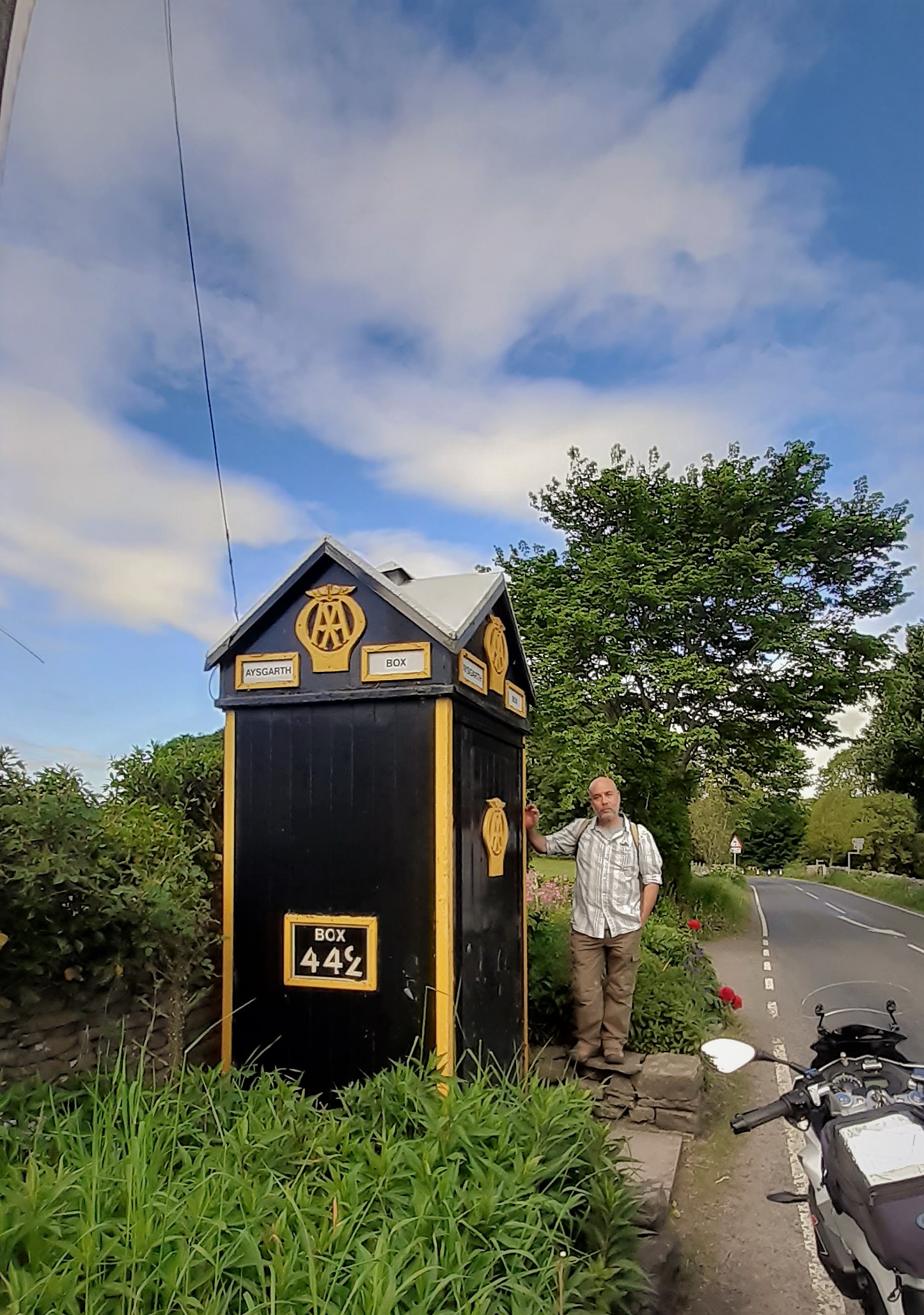 a man standing next to a motorcycle