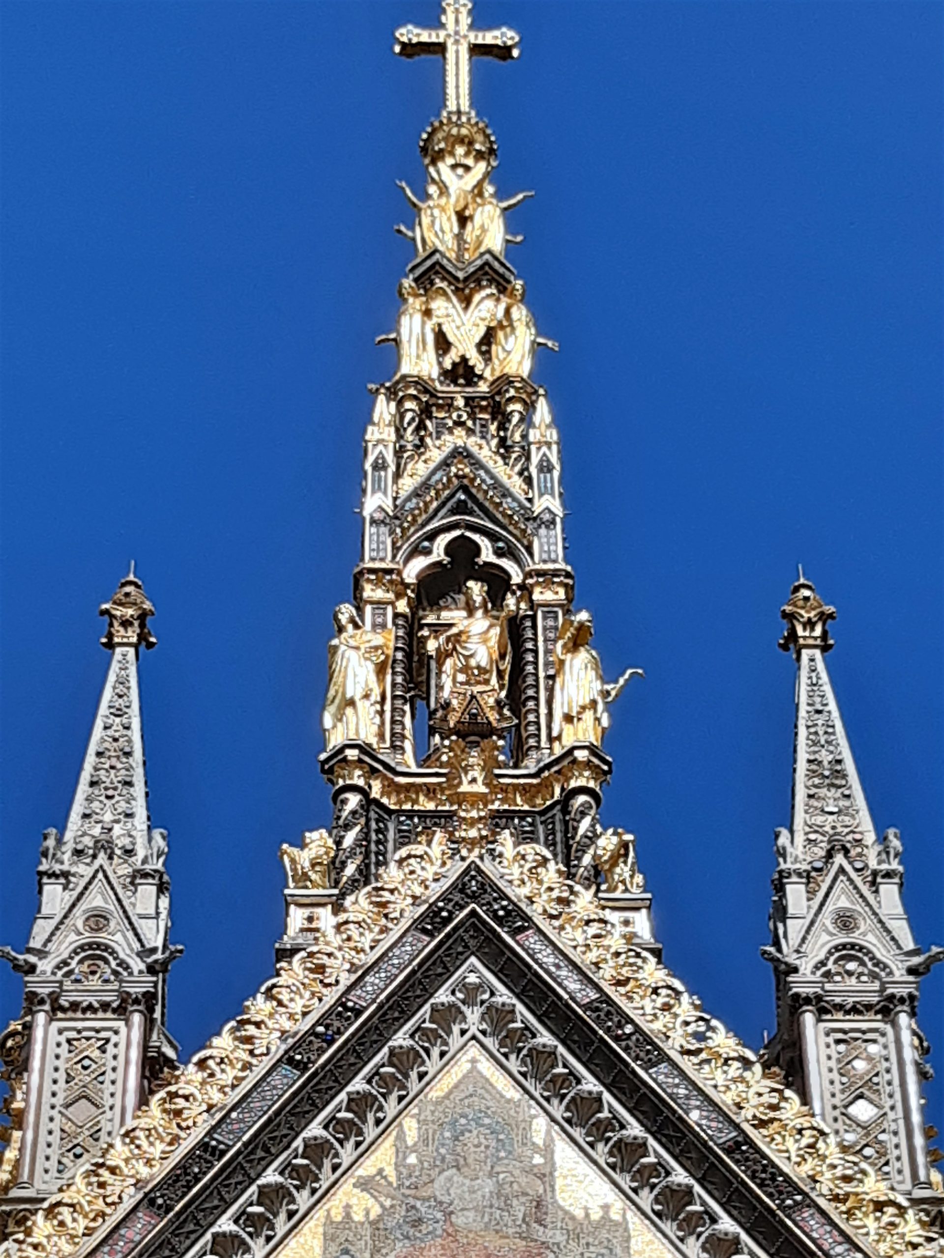 a large tall tower with a clock on the side of a building