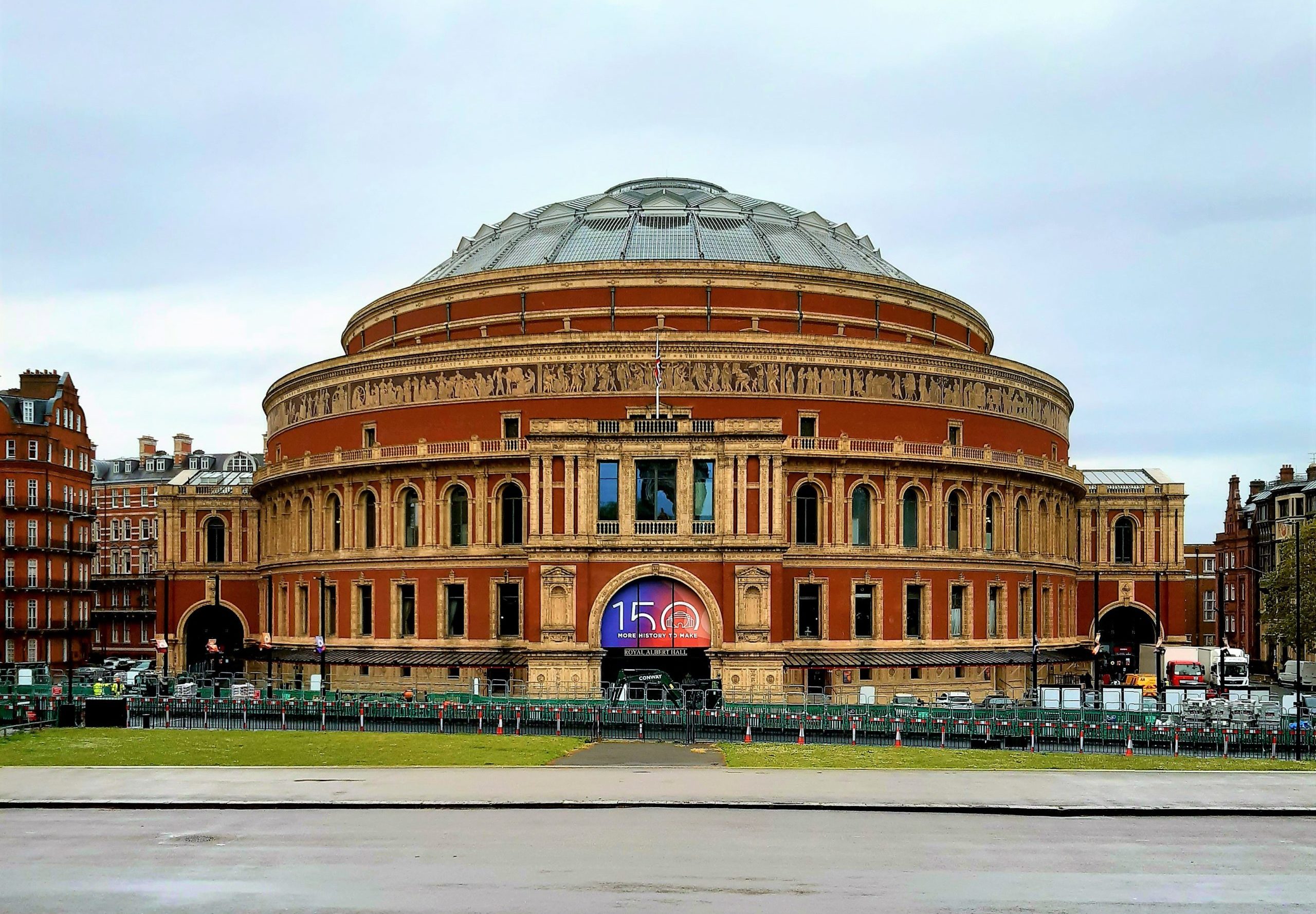 a group of people walking in front of Royal Albert Hall