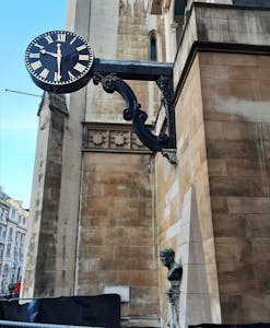 a large clock mounted to the side of a building
