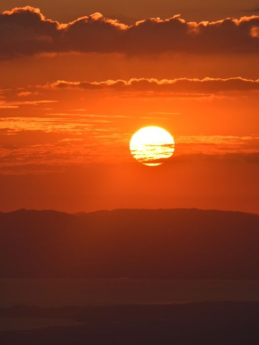 a sunset over the ocean from Cerro Plano Viewpoint