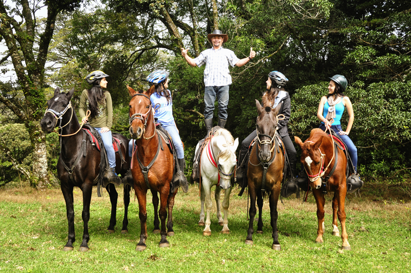 a group of people riding on the back of a horse at Horse Trek Horseback Riding Tour