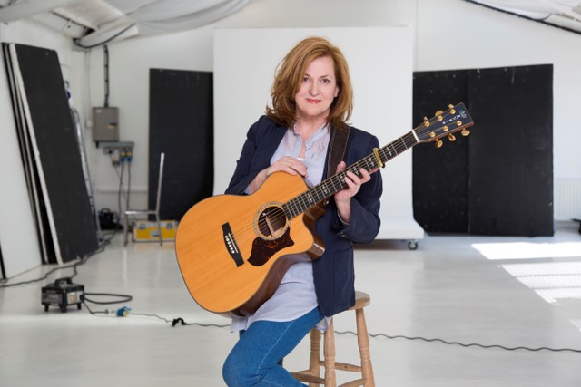 Barbara Dickson holding a guitar