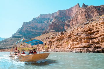 Boat with tourists going down the Grand Canyon river