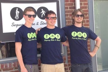 three guys wearing segway bike & stroll shirts